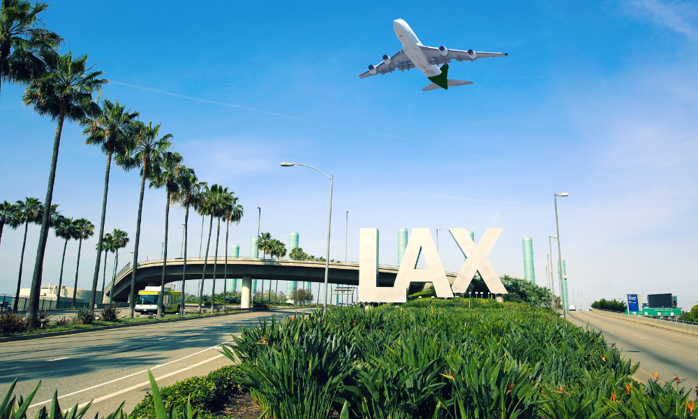 LAX Airport Photo shows airplane in midflight flying over LAX sign